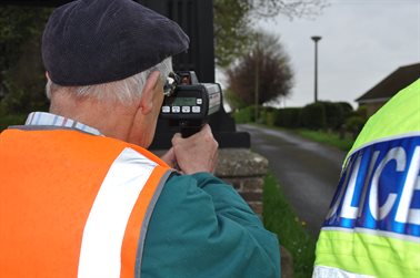 A police traffic officer assists a volunteer during the recent pilot scheme